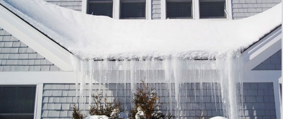 snow and ice on the roof of a home