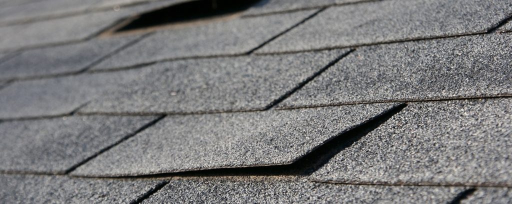 damaged residential roof shingles
