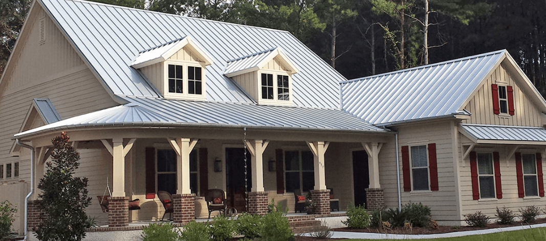 large tan house with light grey metal roofing