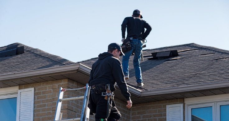 roofers installing a roof on home