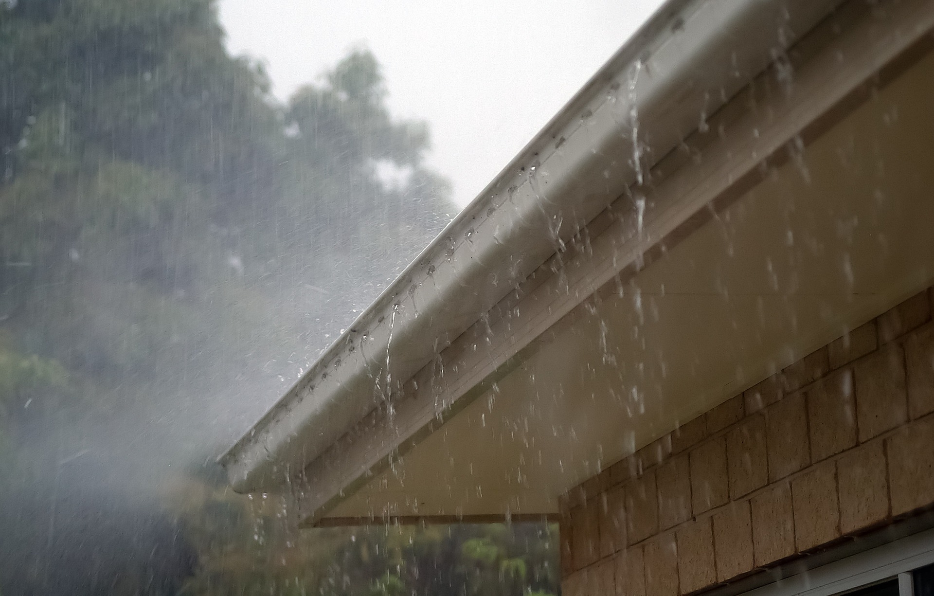 heavy rainfall filling gutter up with rainwater