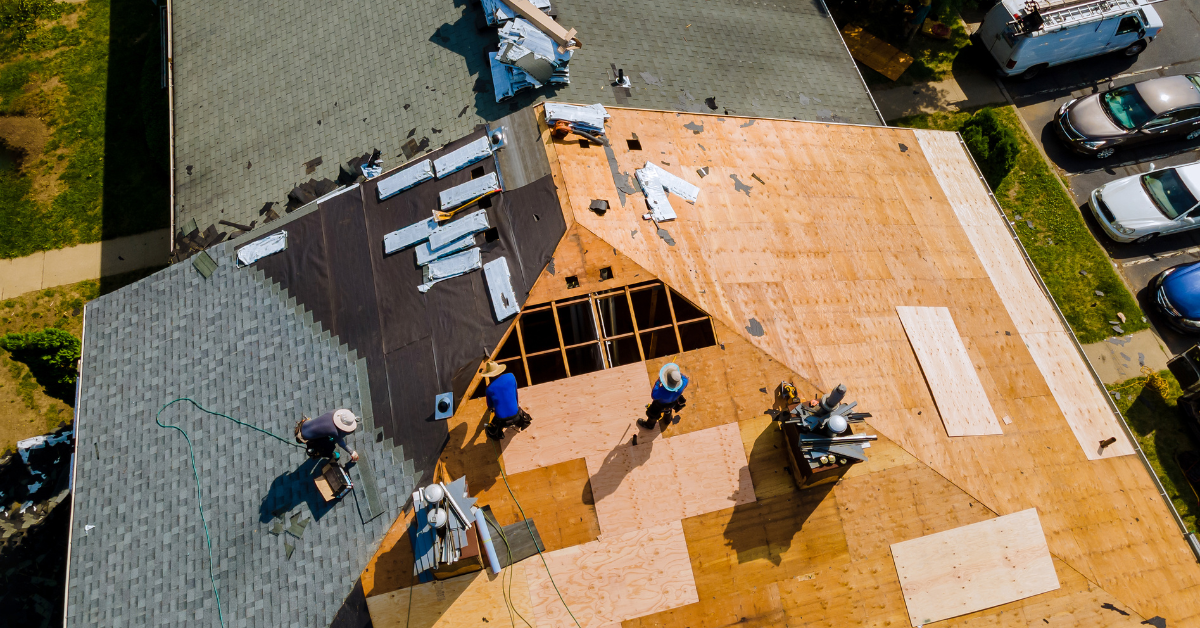 Roofer's putting together a roof, mid-day.