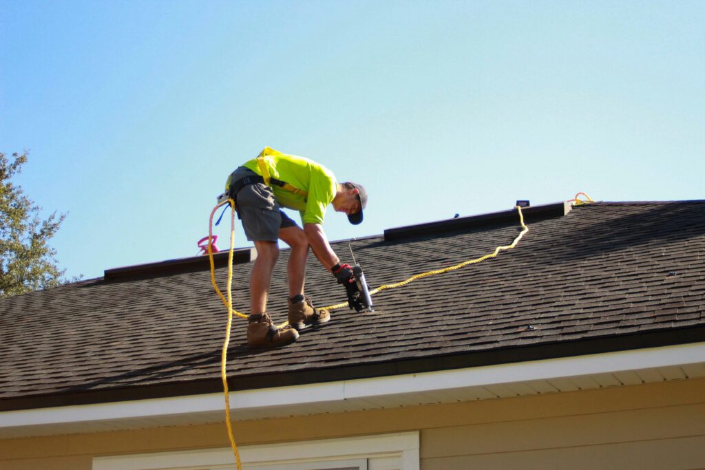 Roofer making roof repairs on a residential home
